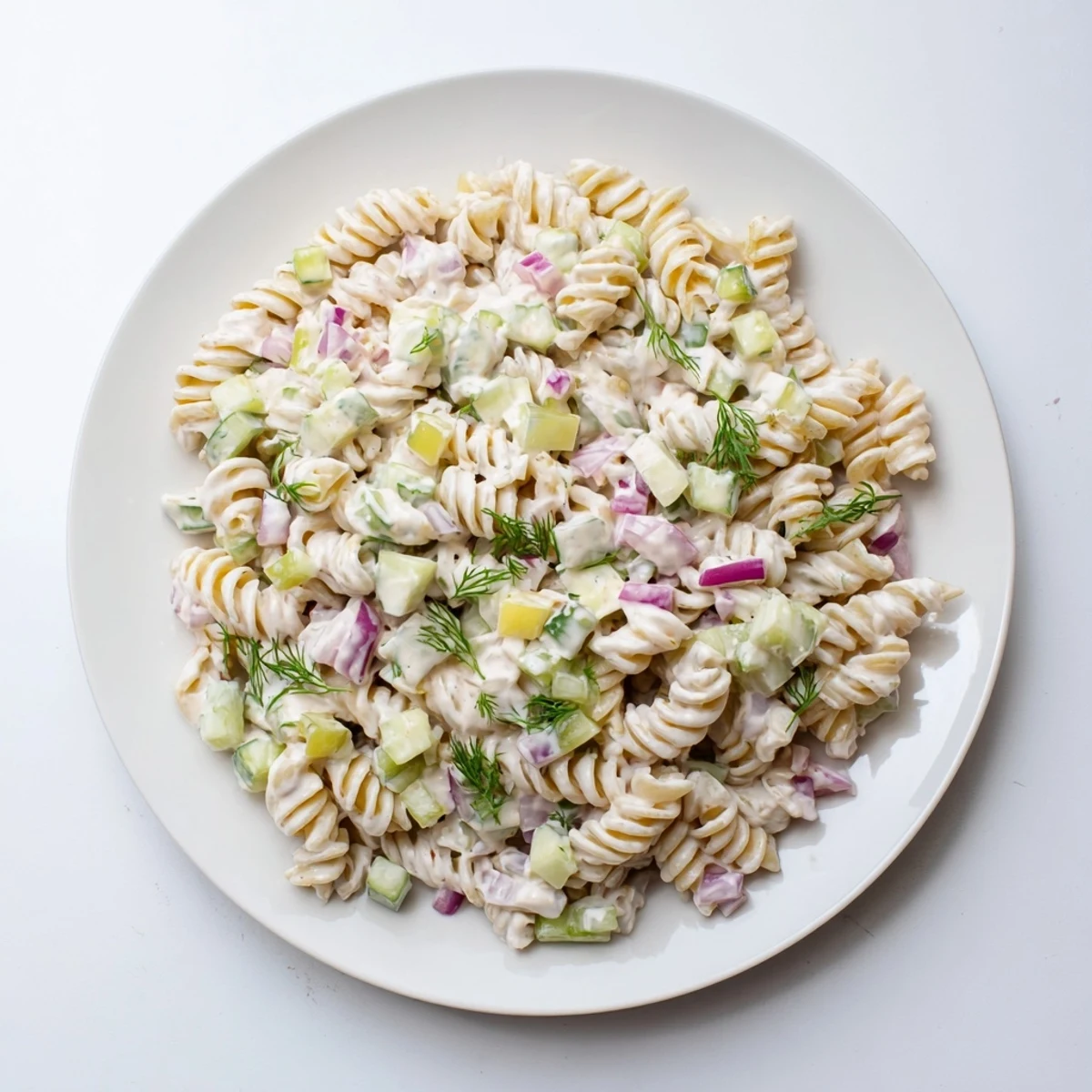 Vibrant Dill Pickle Pasta Salad, chilled and ready to serve, perfect for a summer picnic.