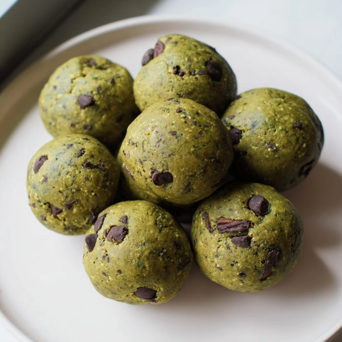 Matcha Gingerbread Cookie Dough Protein Bites, rolled into neat balls ready to chill and enjoy.