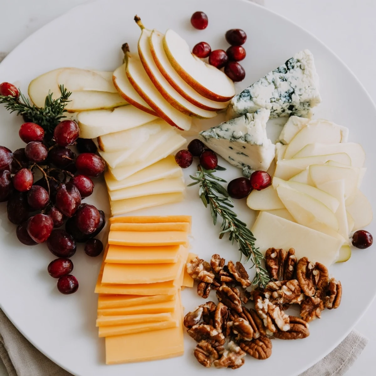 The Winter Cabin Cheese Display features creamy brie, crisp fruit, and roasted nuts arranged artfully on a board.