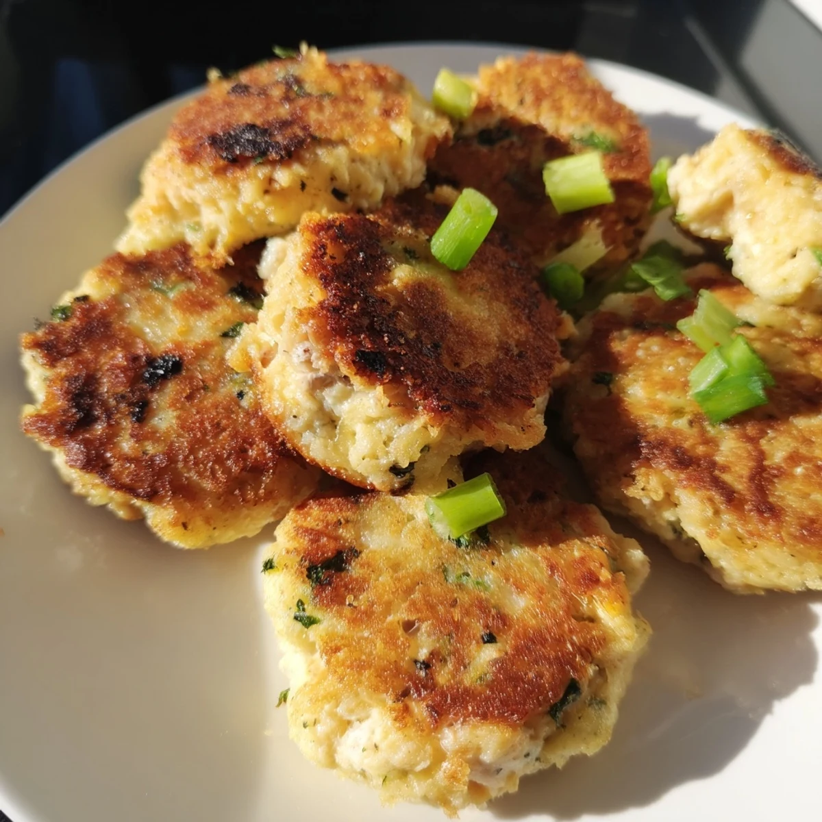 Golden Potato and Chicken Cakes, their crispy edges tempting next to a fresh parsley garnish.