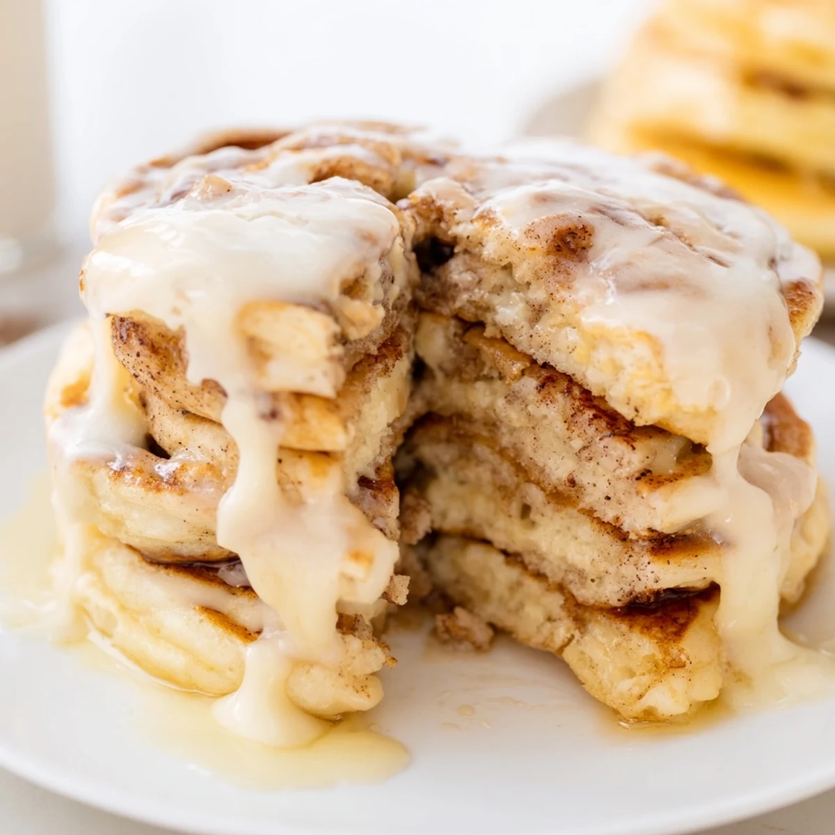 Enjoy mouthwatering Cinnamon Roll Pancakes, ready to be devoured, with a delicate cinnamon flavor and sweet icing.