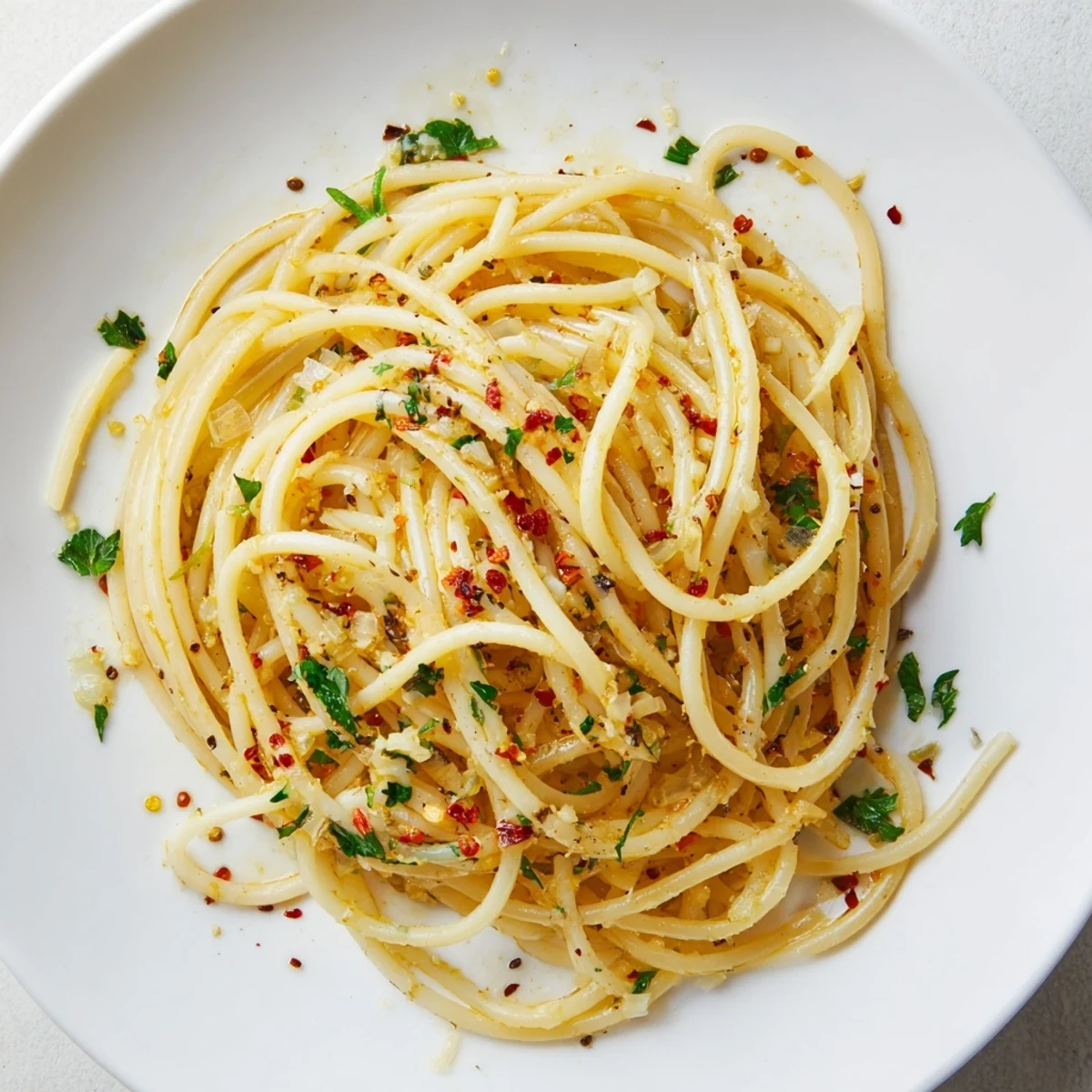 Golden garlic sizzles in olive oil, coating the spaghetti of this quick Aglio e Olio Express Pasta.