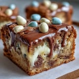 Cadbury Egg Blondies with White Chocolate Drizzle are golden and chewy, bursting with colorful Mini Eggs and a glossy white chocolate finish.