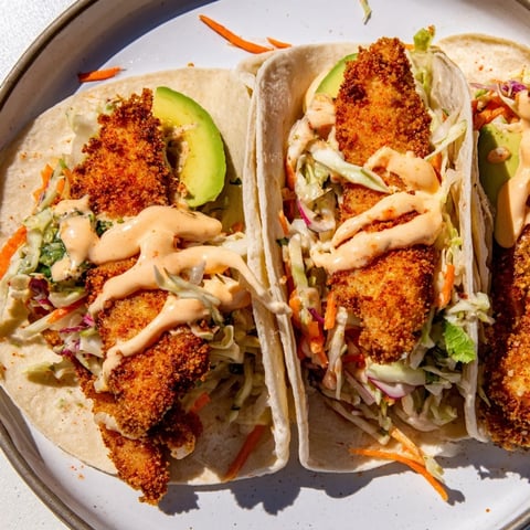 Golden, flaky Crispy Fish Tacos with a vibrant slaw, ready for a satisfying, fresh bite.