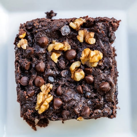 Fudgy and delicious black bean brownies, topped with melting chocolate chips, ready to eat.