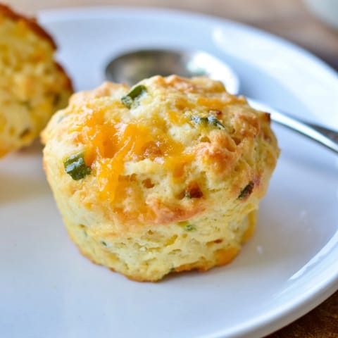 Savory Cheesy Jalapeño Sweet Tea Biscuit Muffins served warm with honey butter drizzle.  