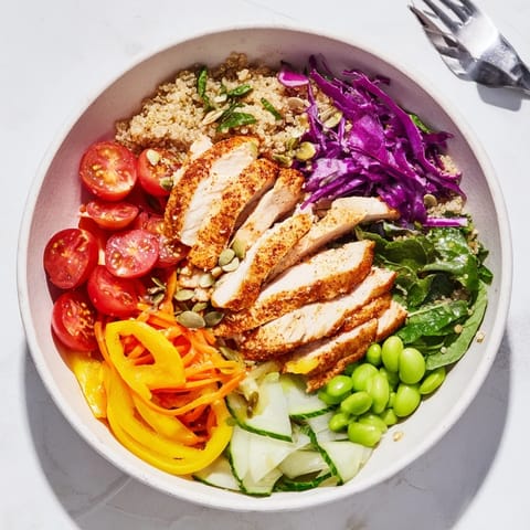 Healthy Meal-Prep Bowls filled with layers of fresh vegetables, grilled chicken, and spices.  