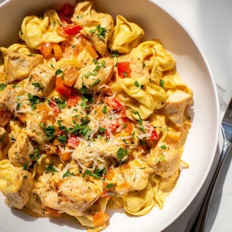 Creamy Zesty Cajun Garlic Parmesan Chicken Tortellini served in a skillet, perfect for dinner.  