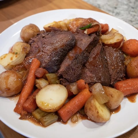 A close-up shot of a flavorful Sunday Pot Roast brimming with vibrant, roasted root vegetables.
