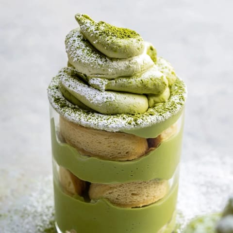 Creamy matcha mascarpone tiramisu snow cups, a delightful dessert with matcha powder snow topping.
