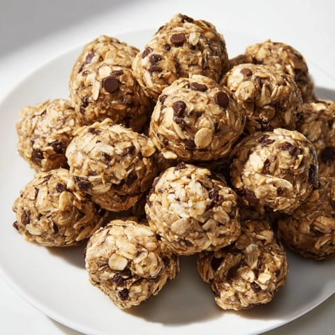 Freshly rolled banana chocolate chip energy balls with oats and chocolate chips, perfect for a healthy on-the-go snack.
