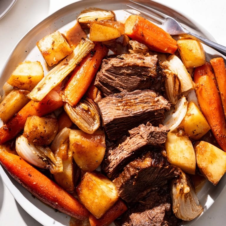 Aromatic Sunday pot roast in a Dutch oven, served with seasonal roasted vegetables.  
