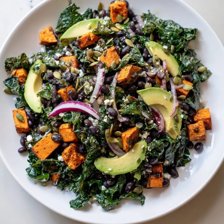 Freshly tossed Massaged Kale Salad featuring dark green kale, a colorful mix of veggies, and a hearty bite.