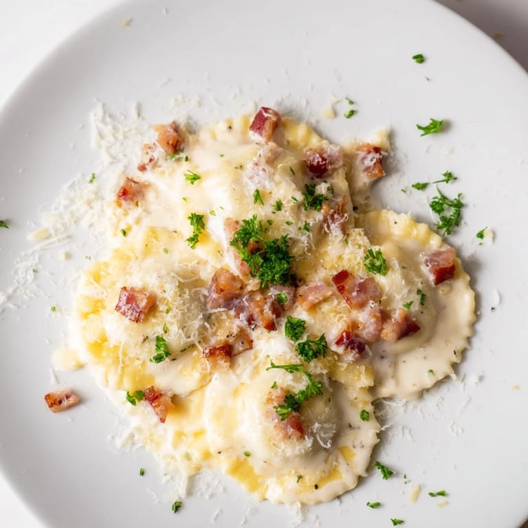 A close-up of Olive Garden Ravioli Carbonara showcases the creamy sauce, cheese, and fresh parsley garnish.