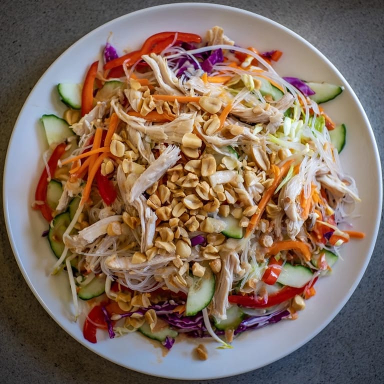 Delicious Vietnamese Crunch Noodle Salad features shredded chicken and crisp vegetables, ready to eat.