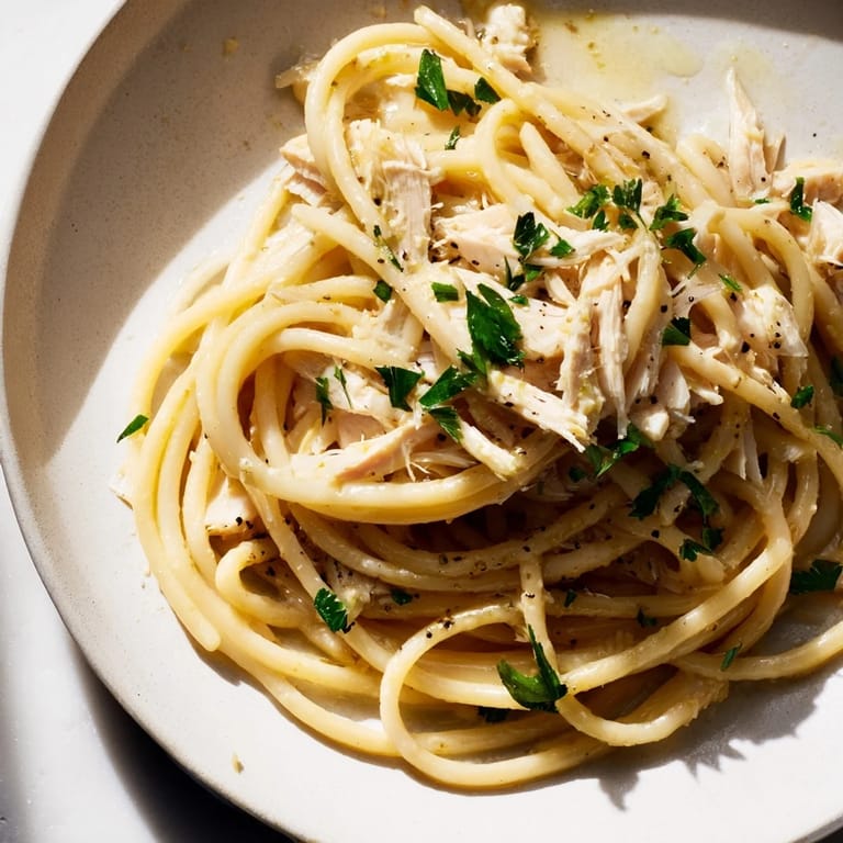 Creamy Simple Garlic Butter Bucatini picture: perfectly twirled pasta with shredded chicken, a quick and delicious recipe.