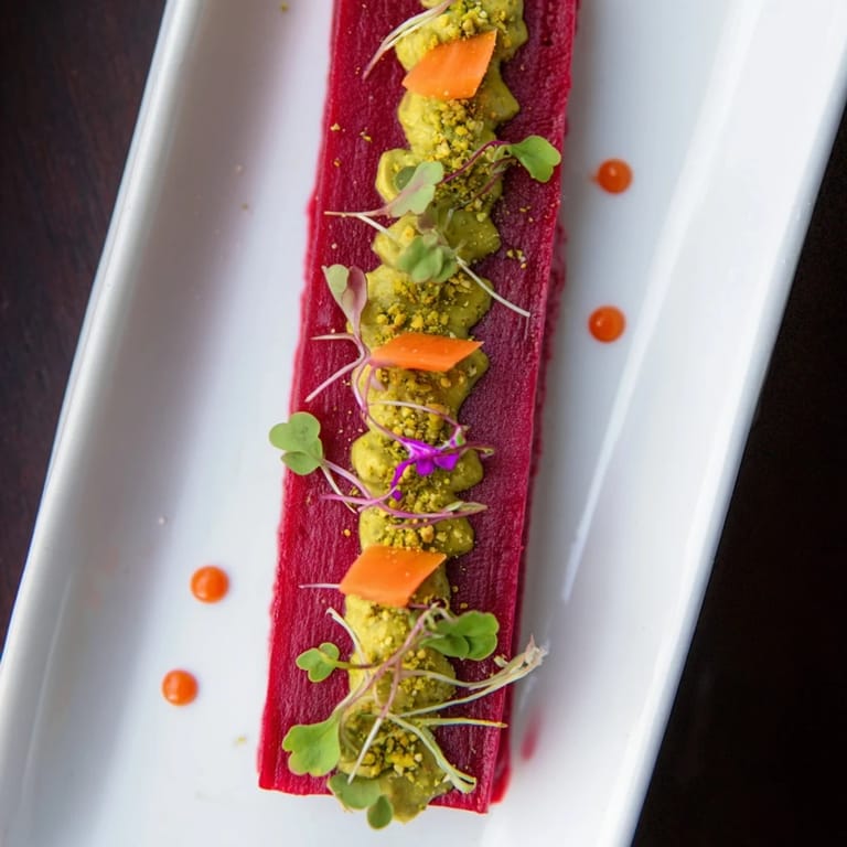 A close-up view of The Modernist Stripe recipe, showing colorful purees artfully arranged to eat.