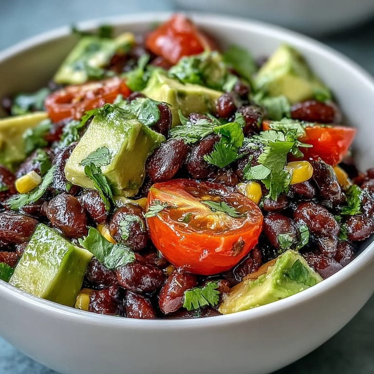 A nourishing Black Bean and Veggie Bowl with black beans, corn, tomatoes, and avocado in a rustic ceramic bowl, perfect for a healthy lunch.