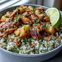 Vibrant Coconut Pineapple Chicken Rice Bowls with juicy chicken, fresh pineapple, and coconut rice topped with herbs and tangy sauce.